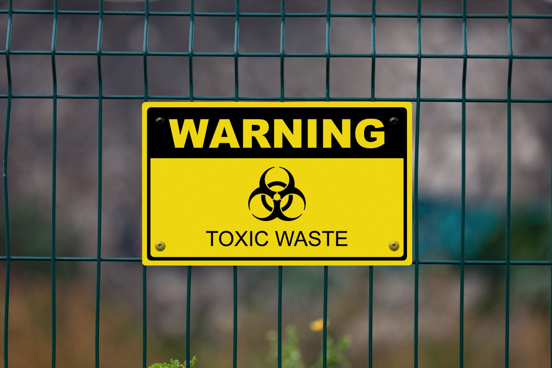 Photo: Sign that says Warning Toxic Waste on a fence. From Canva.