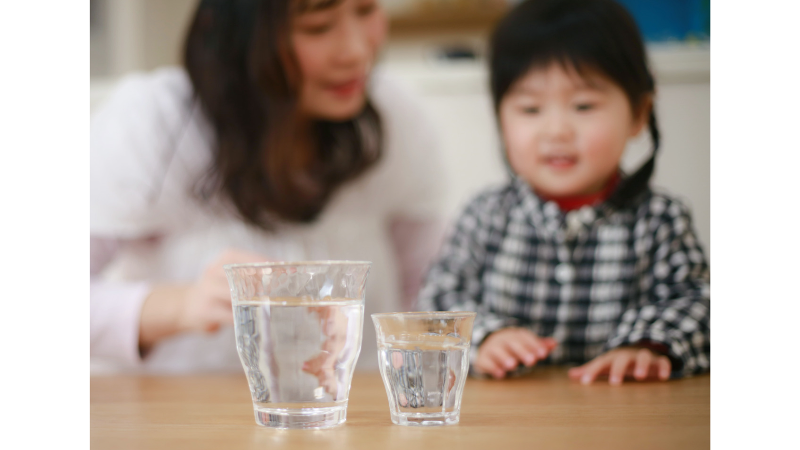 Child and parent with two glasses of water