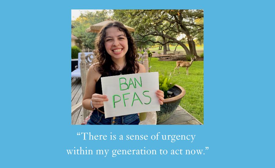 Image of a woman holiding a sign that says "Ban PFAS" in a grassy yard