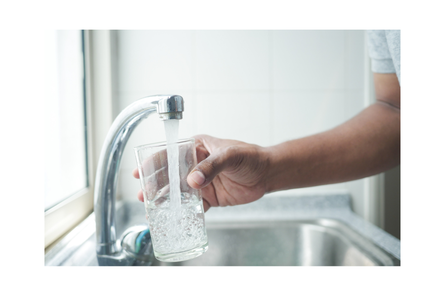 Image of someone pouring water into a glass from a faucet. Canva image.