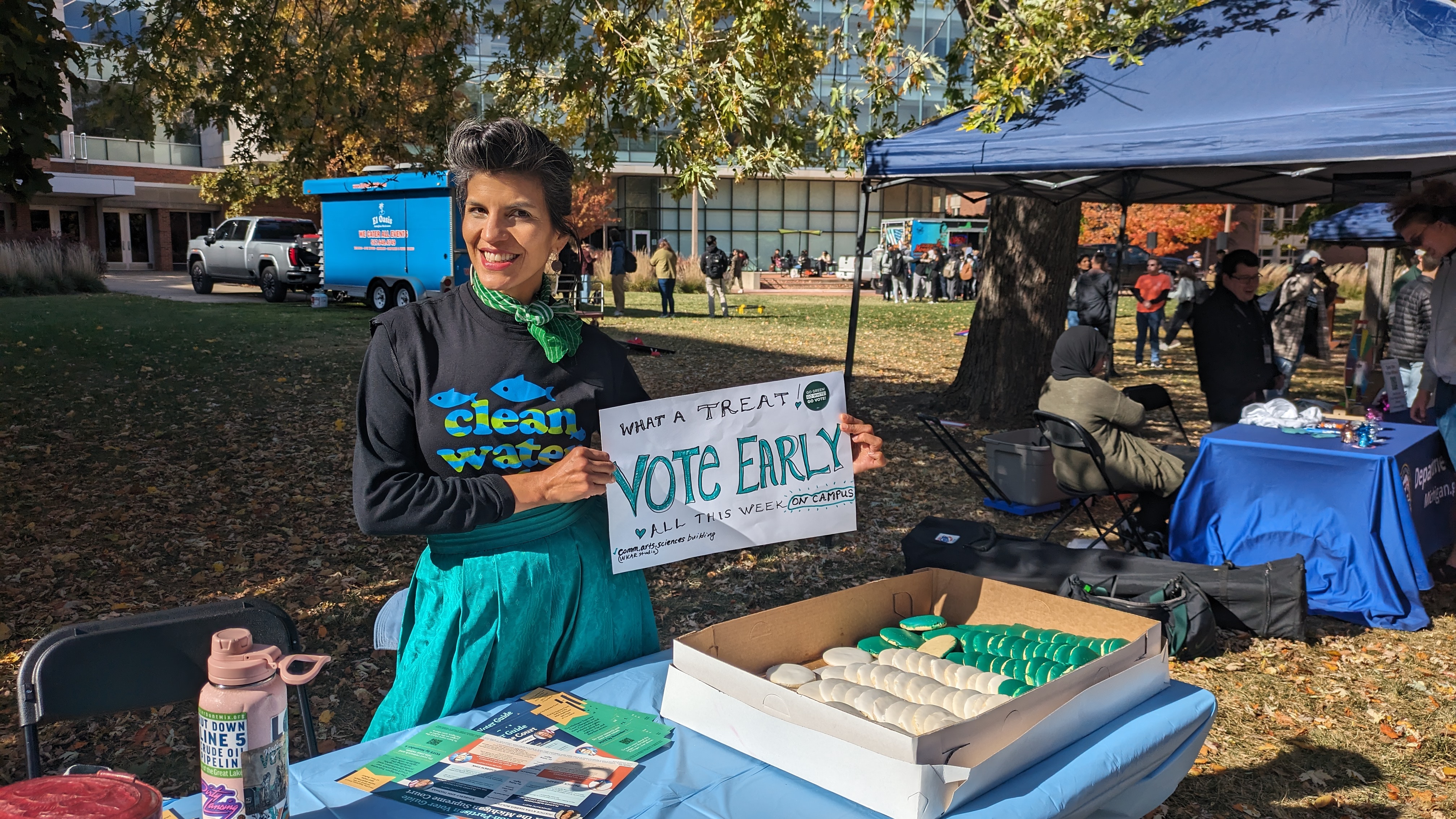 Clean Water Mid MI Organizer Dr Nichole Keway Biber holding a vote early sign on MSU campus