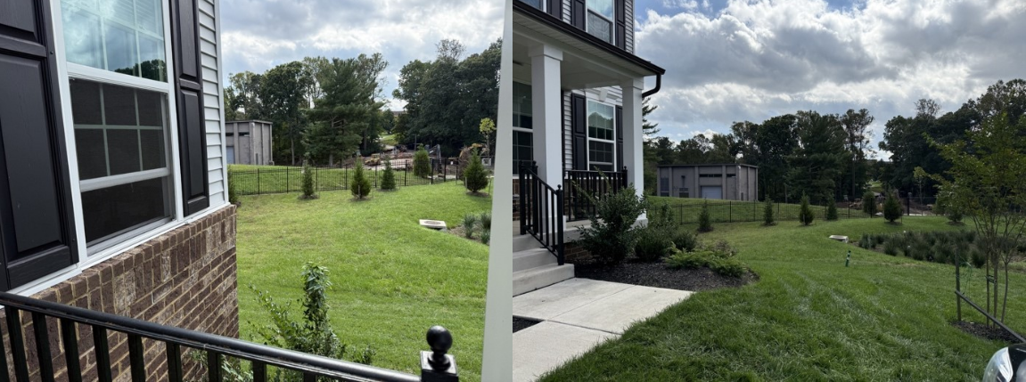 Pictures sideways across the front of a house, with industrial buildings behind a fence in the near background