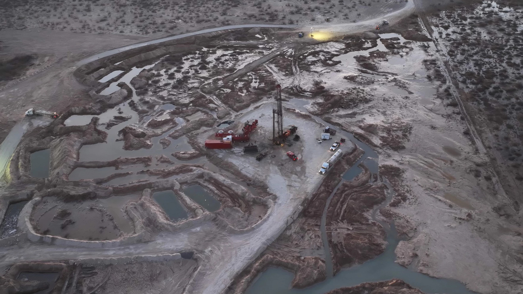 Aerial view of a massive brine release across a stretch of bare industrial land.