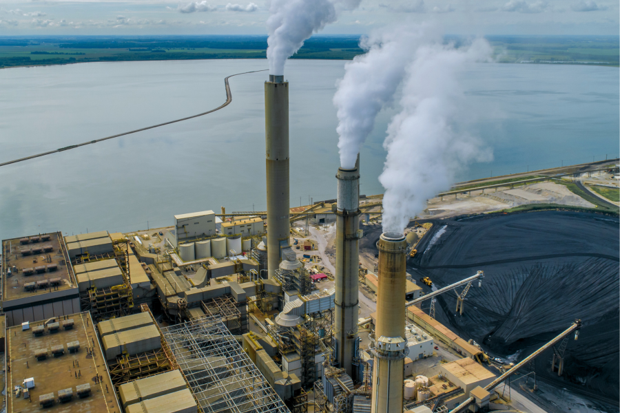 coal plant on a body of water - canva image.