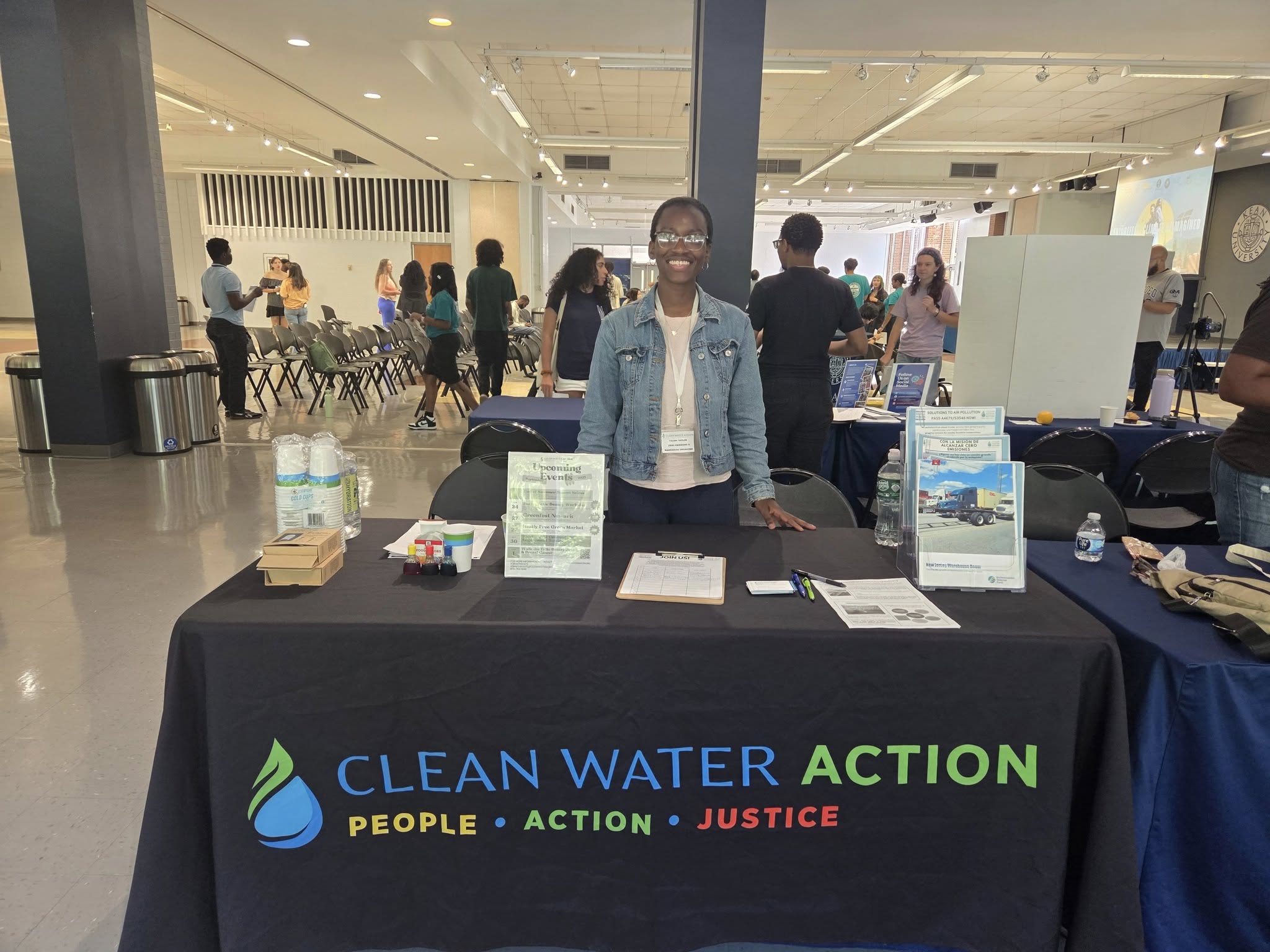 Image of Tolani Taylor at an event table for Climate Week