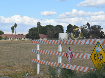 An oil drill located directly next to a family home