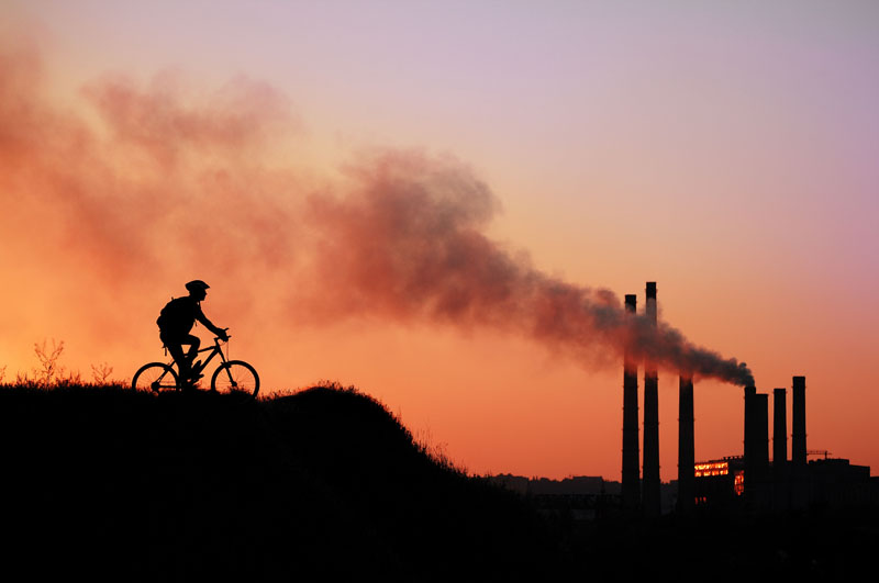 Sunset, powerplant, cyclist. Photo credit: Kalmatsuy / Shutterstock