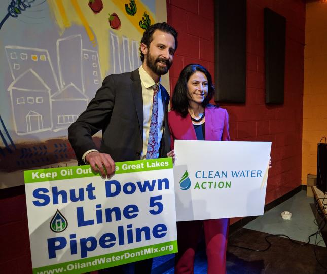 MI - Dana Nessel and Yousef Rabhi at 2019 GLAC award event holding Shut Down Line 5 and Clean Water Action signs. Source: Jennifer Schlicht