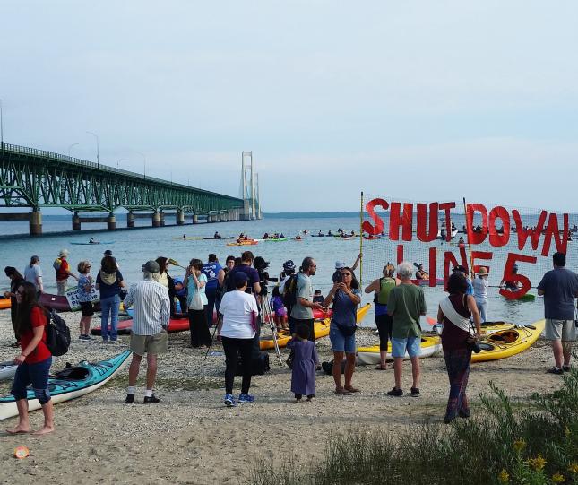Shut Down Line 5 flotilla protest assembling under the Mackinac Bridge