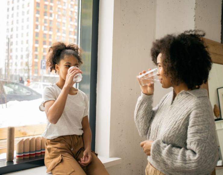 Image of a mom and daughter drinking water