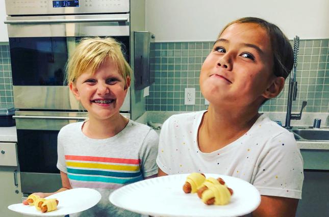 Kids with paper plates before switching to reusable options, San Carlos Youth Center