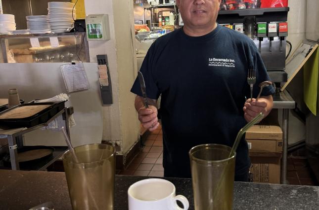 Owner of La Enmarada showing off the new reusable cups and utensils