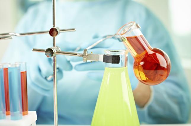 Chemicals being mixed in beakers. Photo credit: mediaphotos / Shutterstock