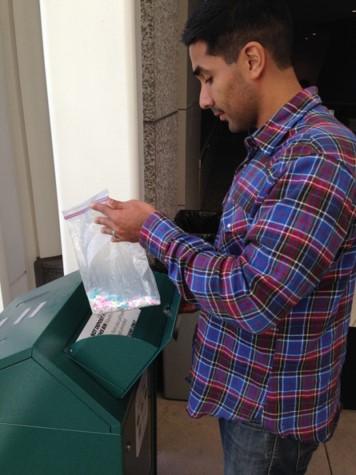 A person properly disposing of medications at a drug disposal drop box