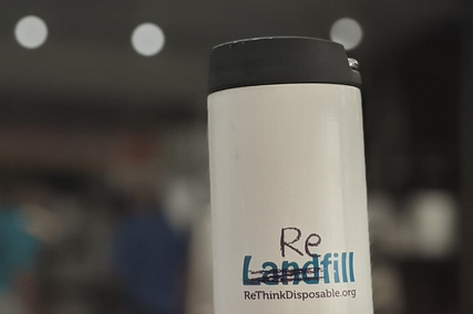 Reusable coffee mug with scribble over the word "Landfill" to read "Refill". Rethinkdisposable.org