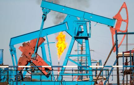 Pumpjacks with a methane flare in the background. Photo credit: Leonid Ikan / Shutterstock