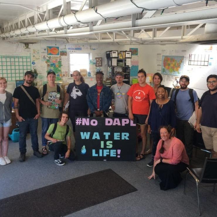 Clean Water Staff posing with "No DAPL - Water Is Life!" sign