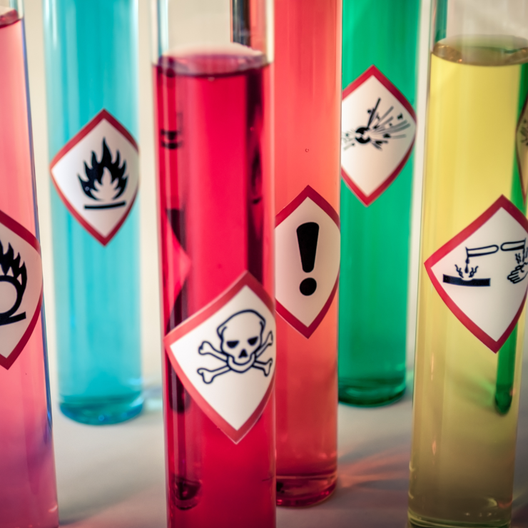 Test tubes of chemicals with warning labels