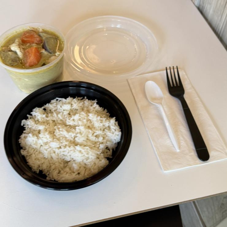 Single use plastic bowls and utensils with thai food