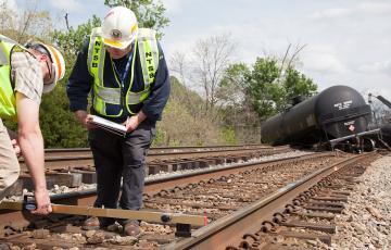 NTSB Rail Safety Investigators on scene in Lynchburg, VA NTSB rail investigator Richard Hipskind documents track damage on scene of train derailment in Lynchburg, VA. Photo by  National Transportation Safety Board