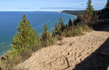 Heart drawn in sand on ridge overlooking Lake Michigan and Sleeping Bear Dunes