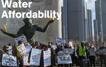 Water affordability protestors in Detroit holding signs in front of Spirit of Detroit statue. Text: Water Affordability 