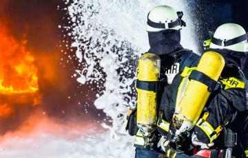 Image of a firefighter and a foam fire extinguisher