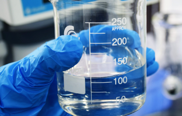 Water sample for testing held in beaker