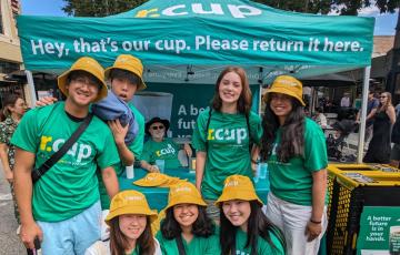 ReThink Disposable volunteers posing in front of returnable cup tent