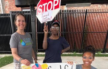 New Jersey Clean Water staff with signs: "Stop Fossil Fuels" "Fossil Fuels are not healthy for children and other living things"