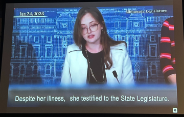 Still from film of Amara Strande, caption: "Despite her illness, she testified to the State Legislature"