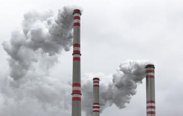 Three power plant smoke stacks. Photo credit: martin33 / Shutterstock