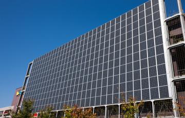 Solar panels on the side of a building. Credit: yoshi0511 / Shutterstock