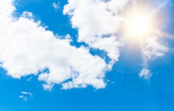 photo of the hot sun and some clouds in the sky-canva image