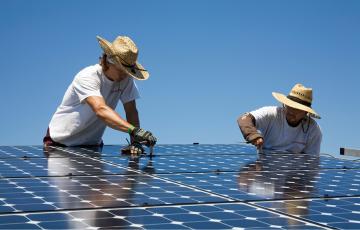 Solar workers installing panels