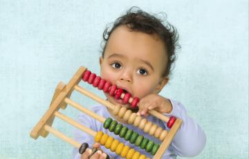 Child playing with toy. Photo credit: Studio-Annika / Shutterstock