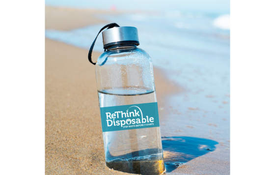 Image of a beach with a reusable water bottle and ReThink Disposable logo on it
