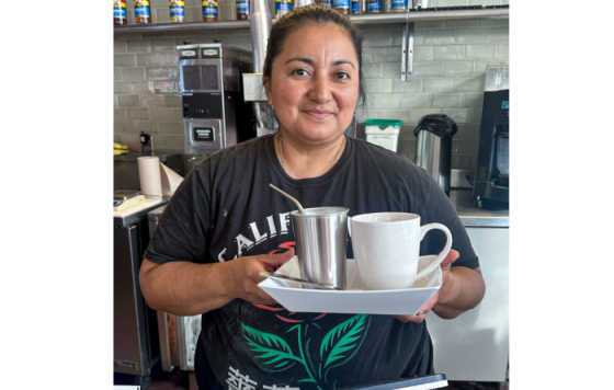 Manager posing with new reusable dishware set