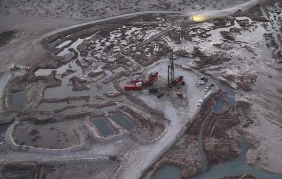 Aerial view of a massive brine release across a stretch of bare industrial land.