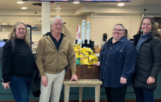 Four people posing at an indoor cafe