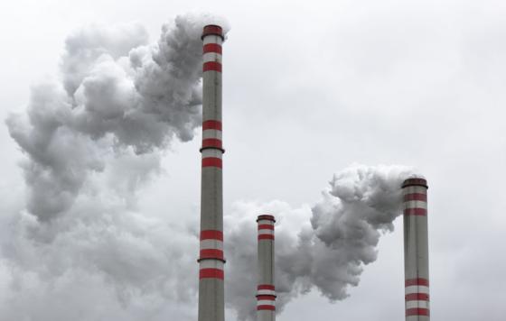 Three power plant smoke stacks. Photo credit: martin33 / Shutterstock